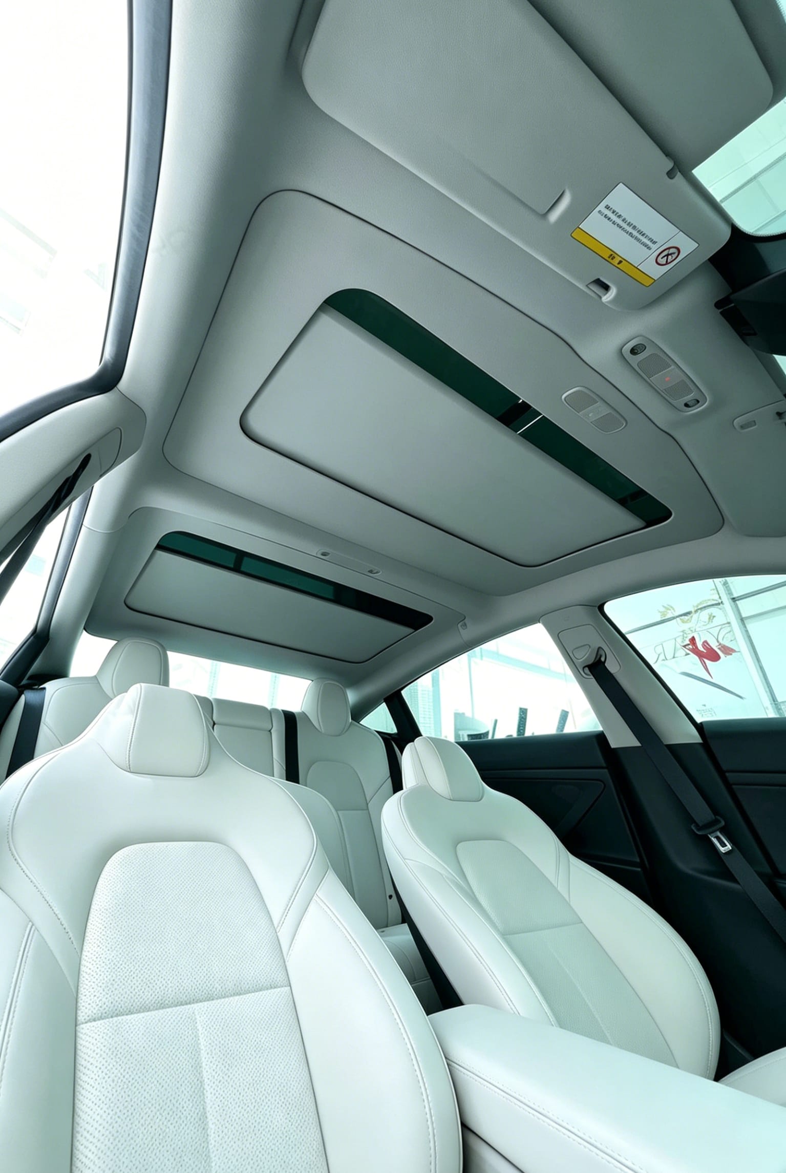Detailed look at the seamless frame fitment of Aegiswarn electric retractable sunshade on Tesla Model 3 panoramic roof edge.